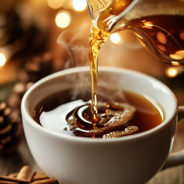 Gingerbread Syrup Pouring Over Coffee, accompanied by cinnamon sticks and a festive Christmas tree in the background.